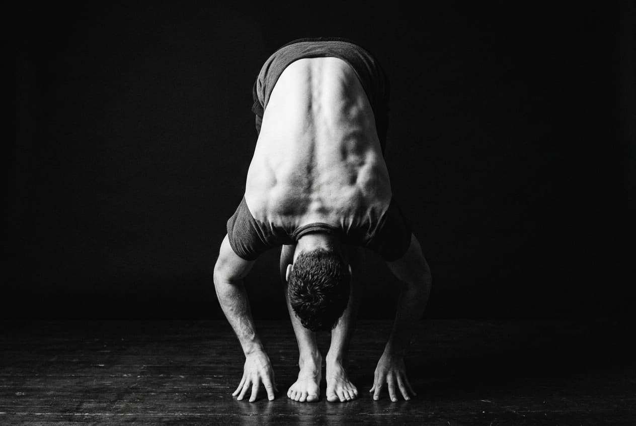 A person on the floor with knees drawn towards the chest