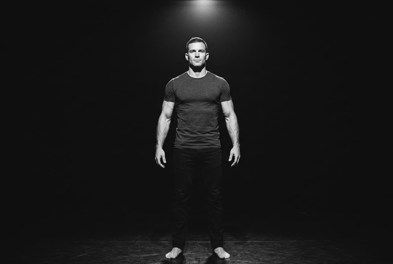 A person standing side-on, shoulders drawn back