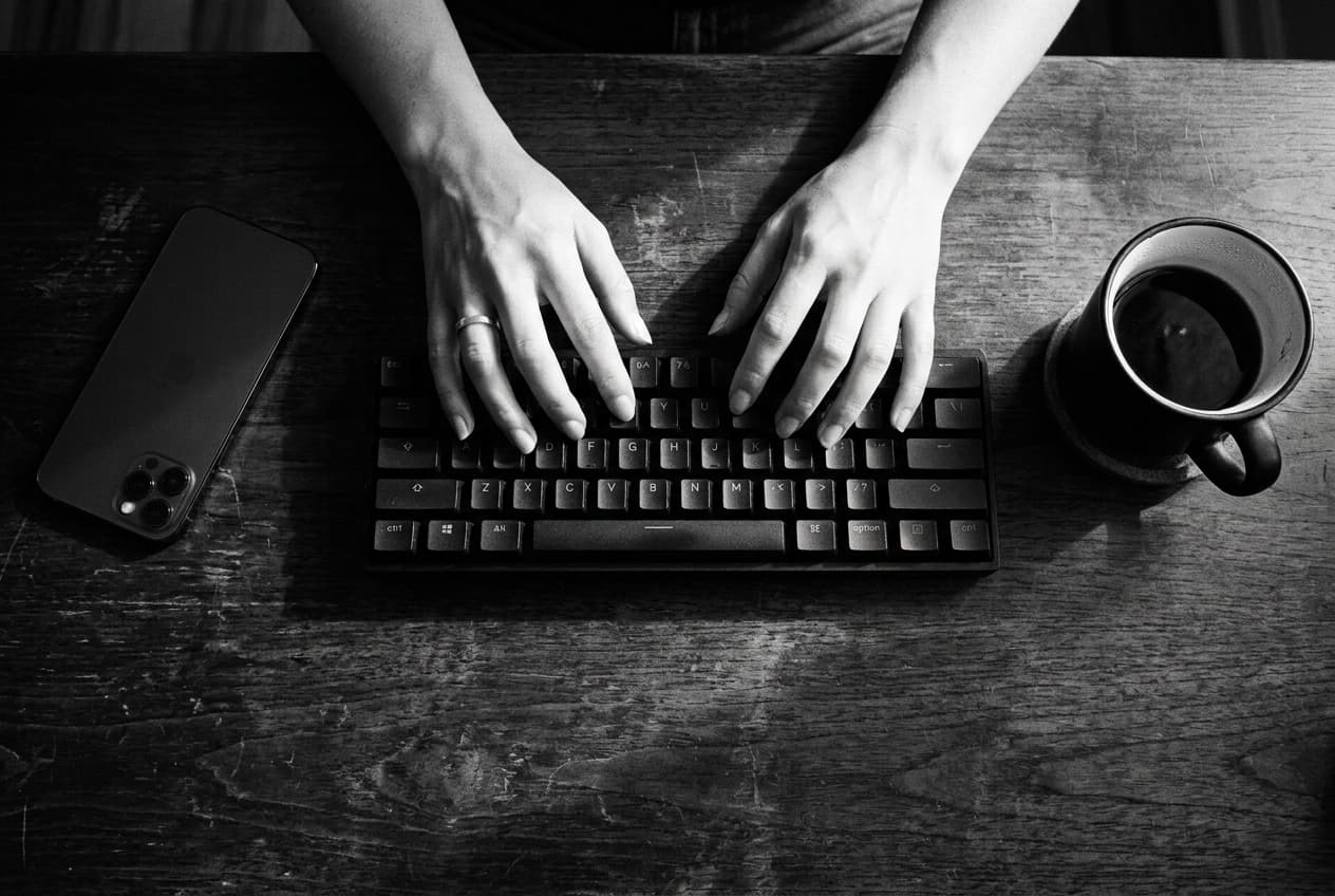 A person working at a desk in low light